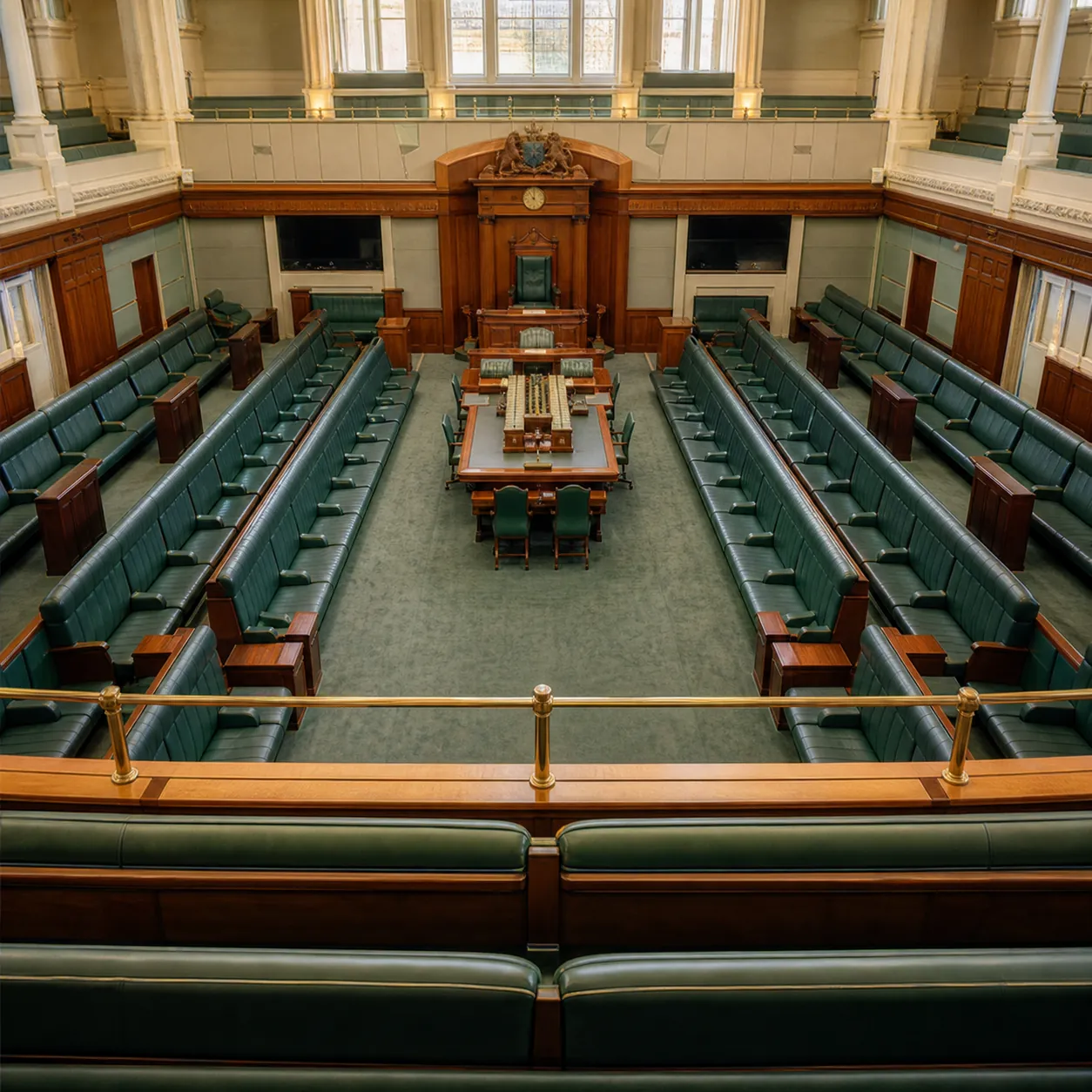 Interior of an Australian parliamentary debating chamber with green benches